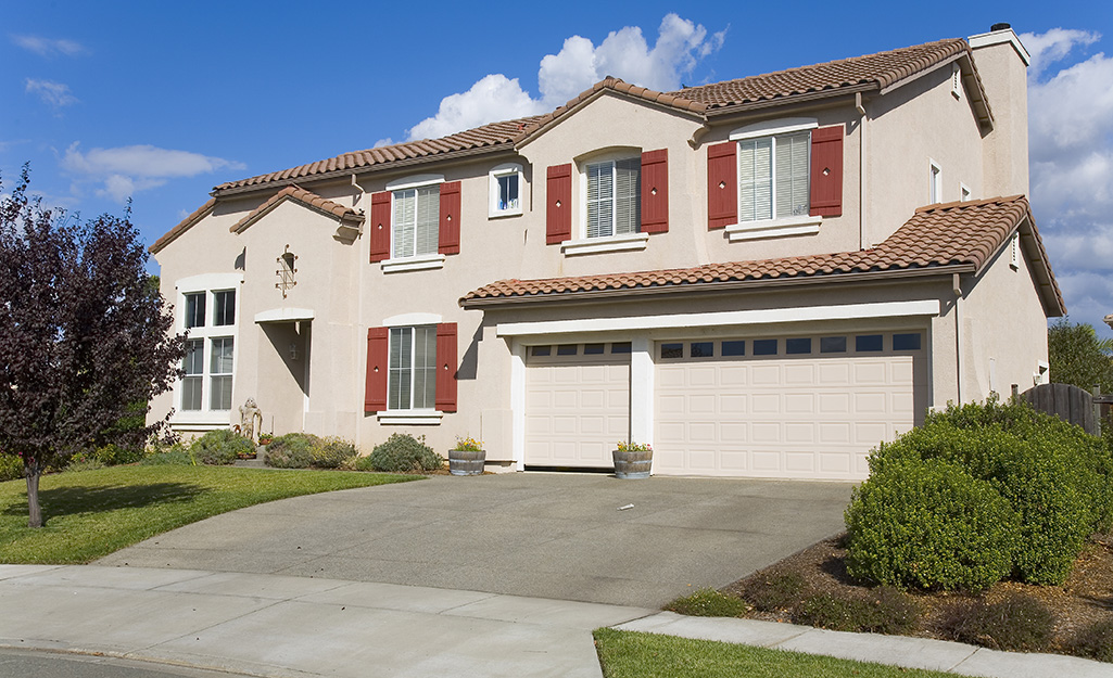 Exterior of a house with a well-maintained concrete driveway.