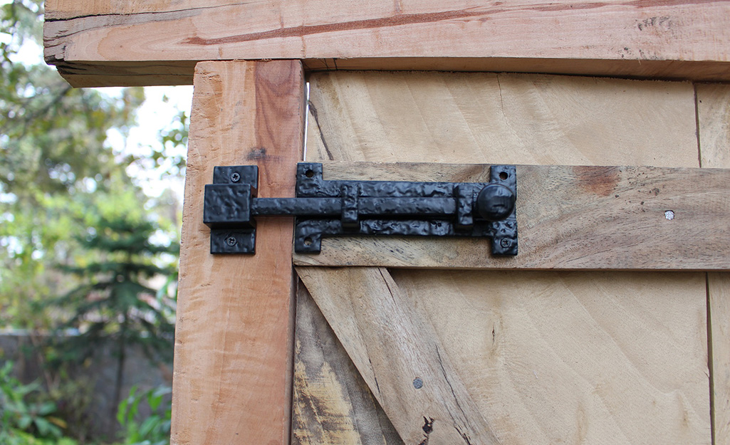 Close image of a iron bolt latch on a wood gate