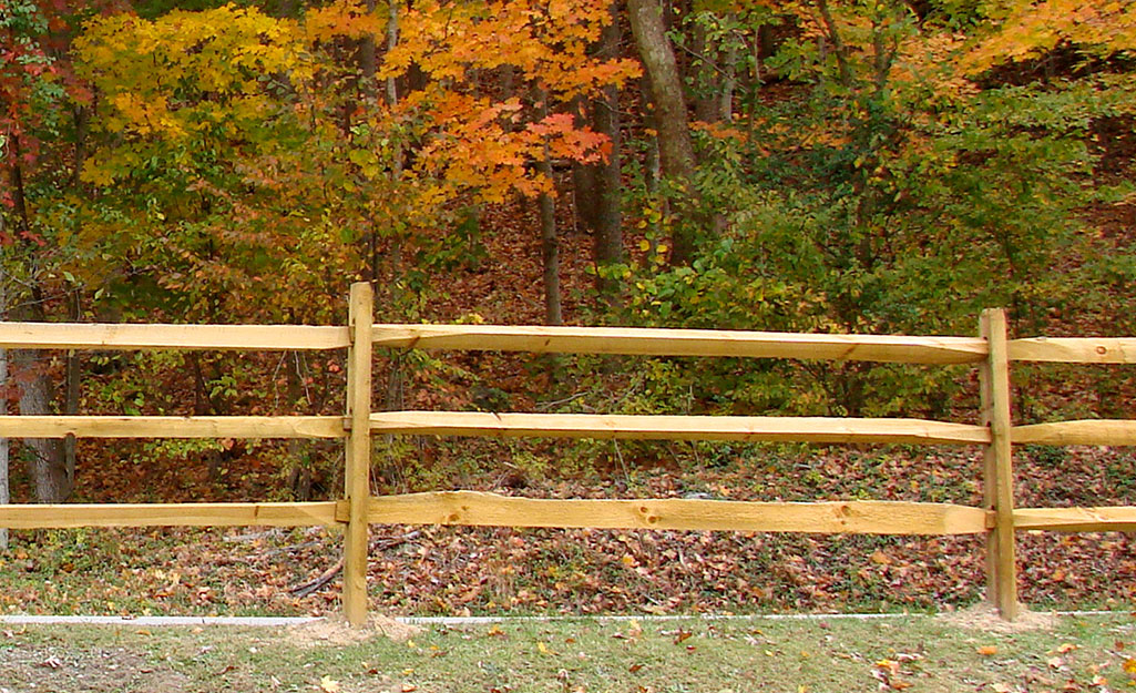 A southern pine split rail fence surrounding a large property.