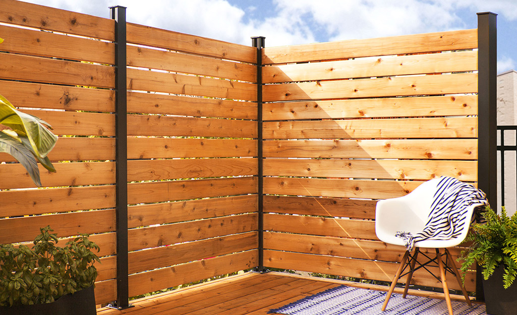 A privacy fence built using redwood slats.