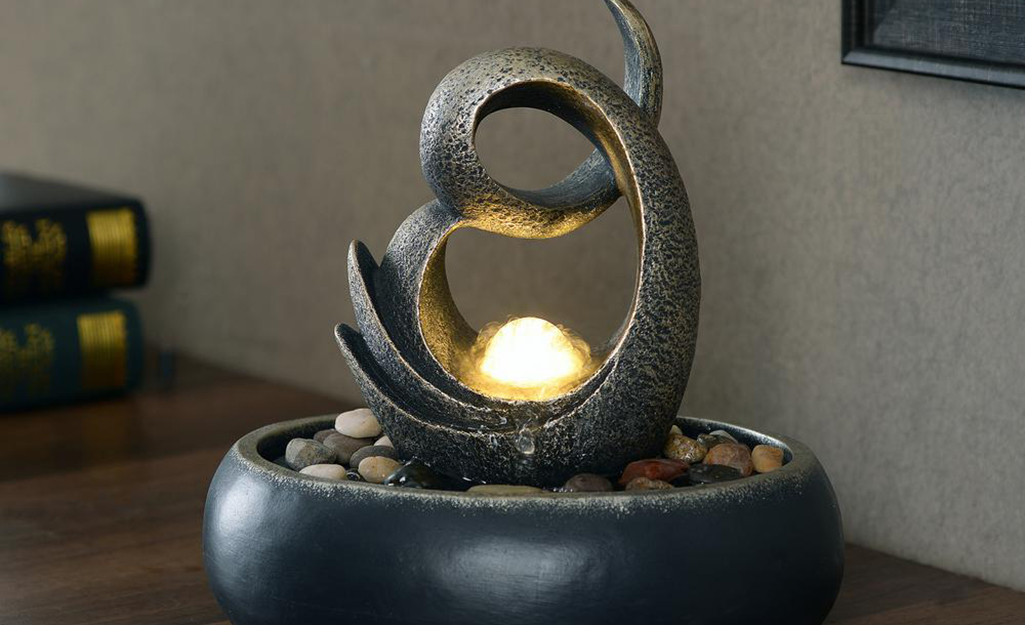 A contemporary tabletop fountain on a desk.