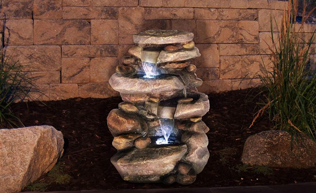 A water fountain with lights illuminating the water.