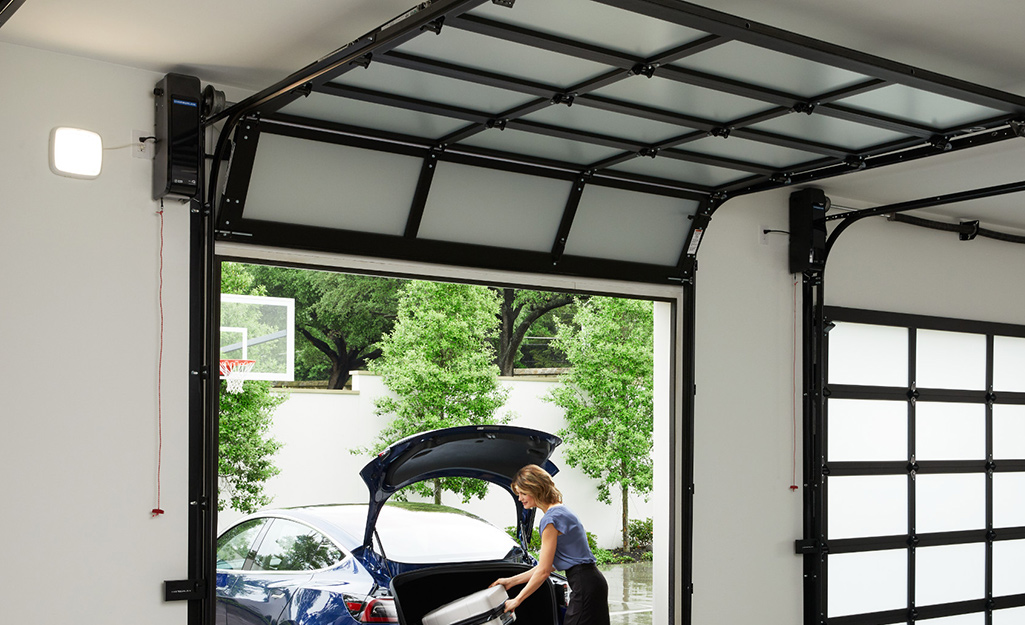 A chain drive garage door opener hangs from a ceiling.
