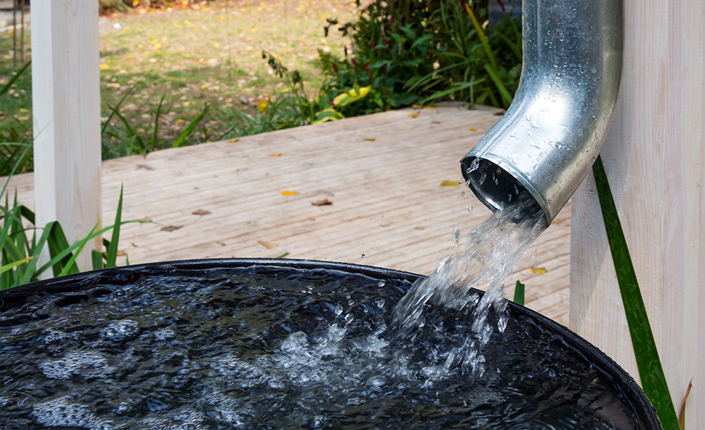 Rain water pouring out of a downspout.