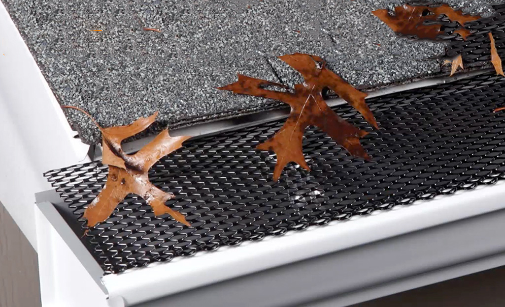 Leaf or debris guard mesh covering gutter on a house.