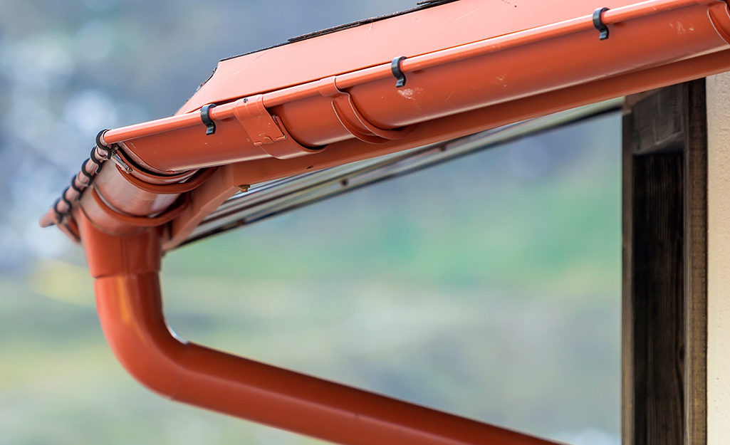 A gutter on a home showing different seams and brackets.