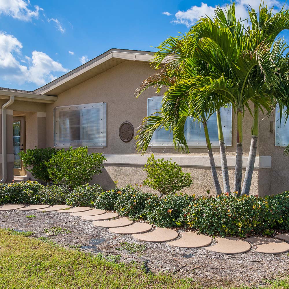 A home with hurricane shutters on the front windows.