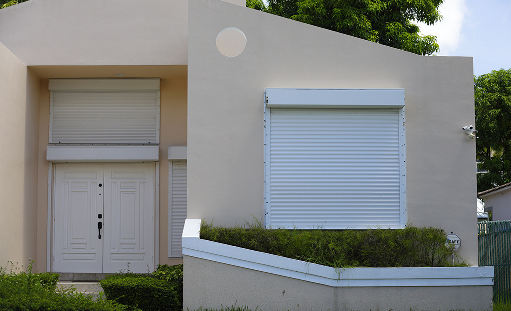 Roll down shutters installed on a home's front windows. 