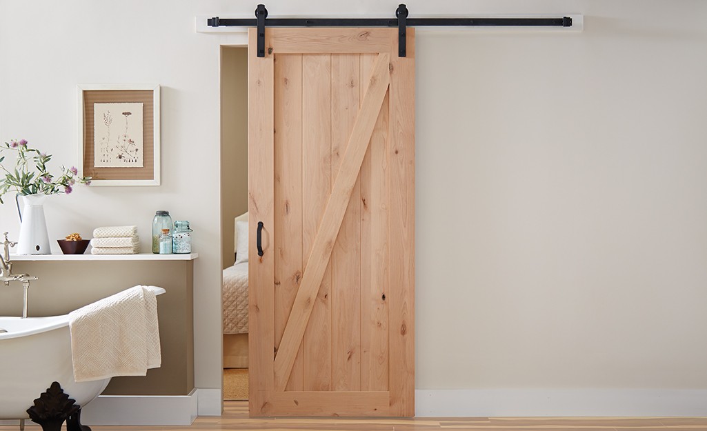 A sliding barn door made of solid wood.