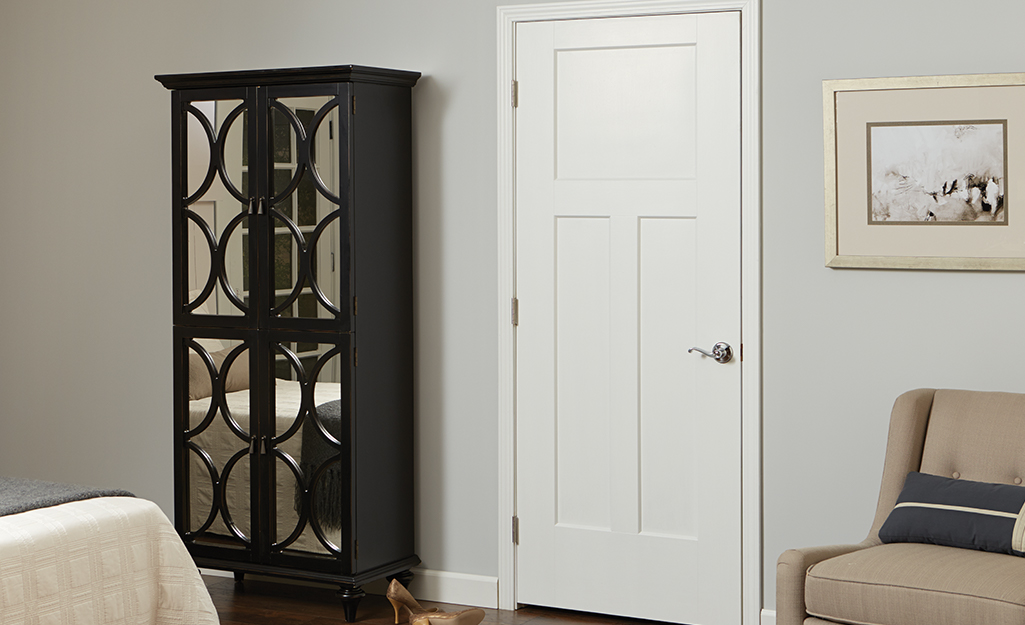 An interior door installed next to a bookcase.