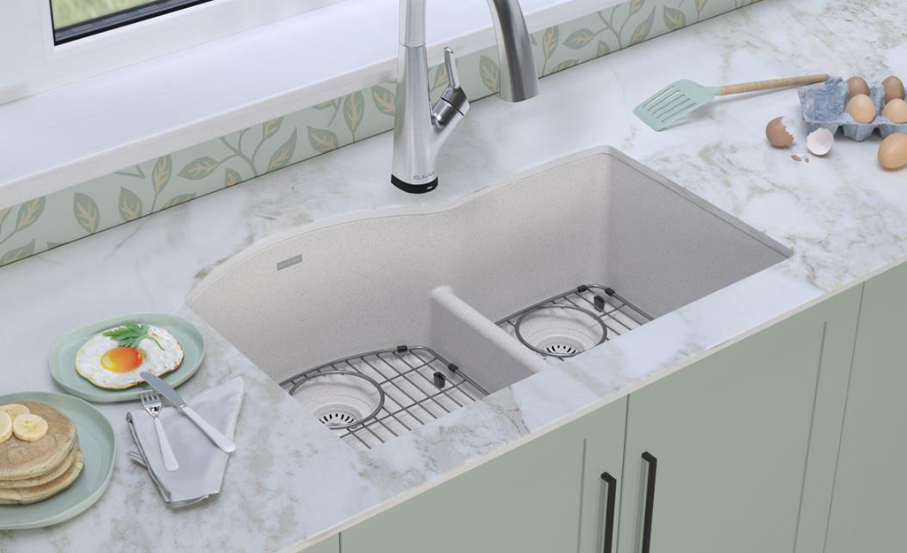 An undermount sink set in a marble countertop.