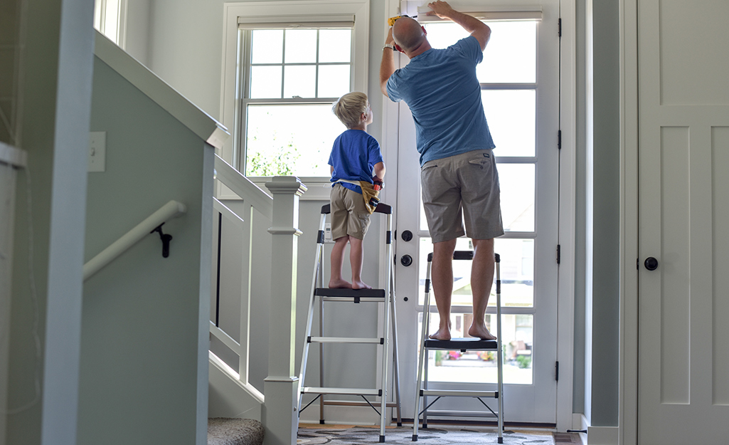 A father and a child each on a step ladder.