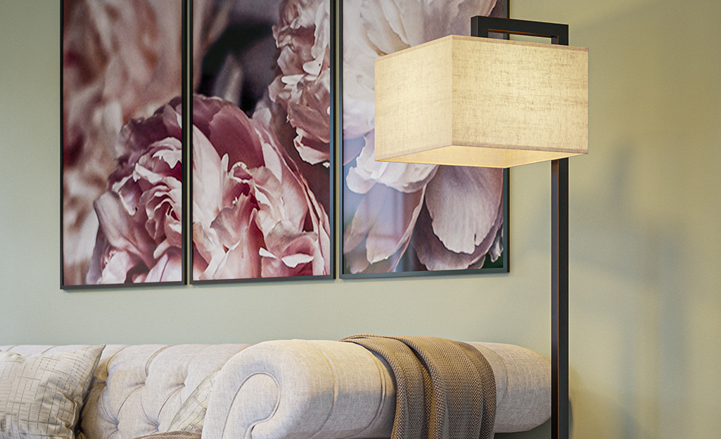 A square lampshade attached to a floor lamp.