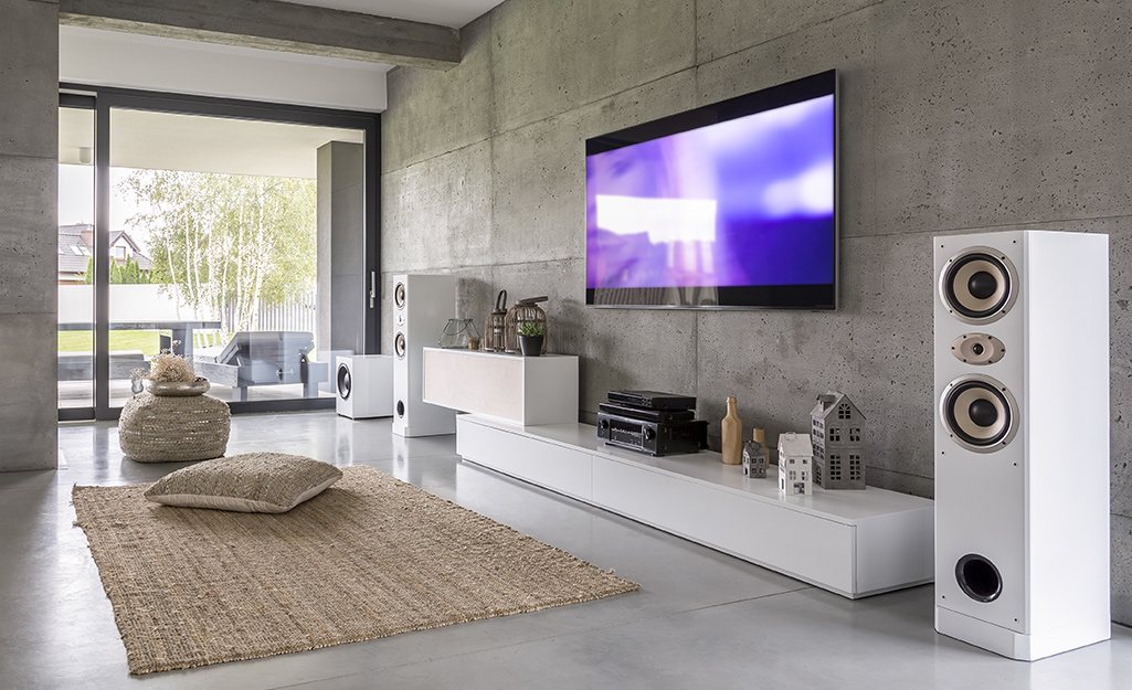 A heavy flat screen TV hangs on a living room wall.