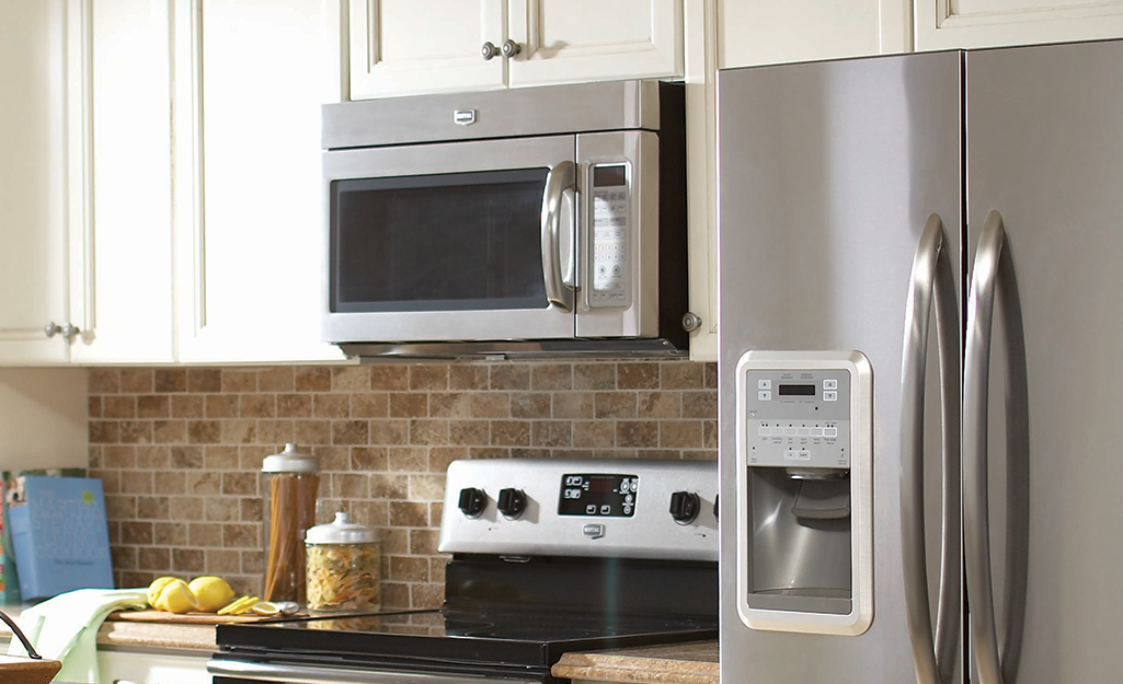 A stainless steel microwave in a kitchen.