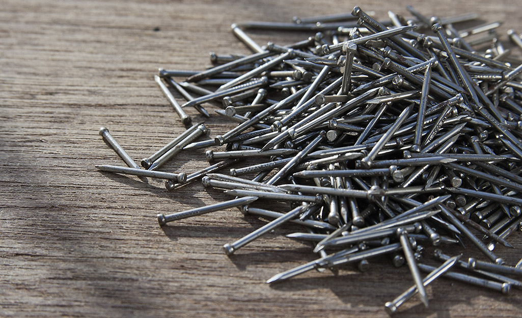 A pile of assorted nails on a table.