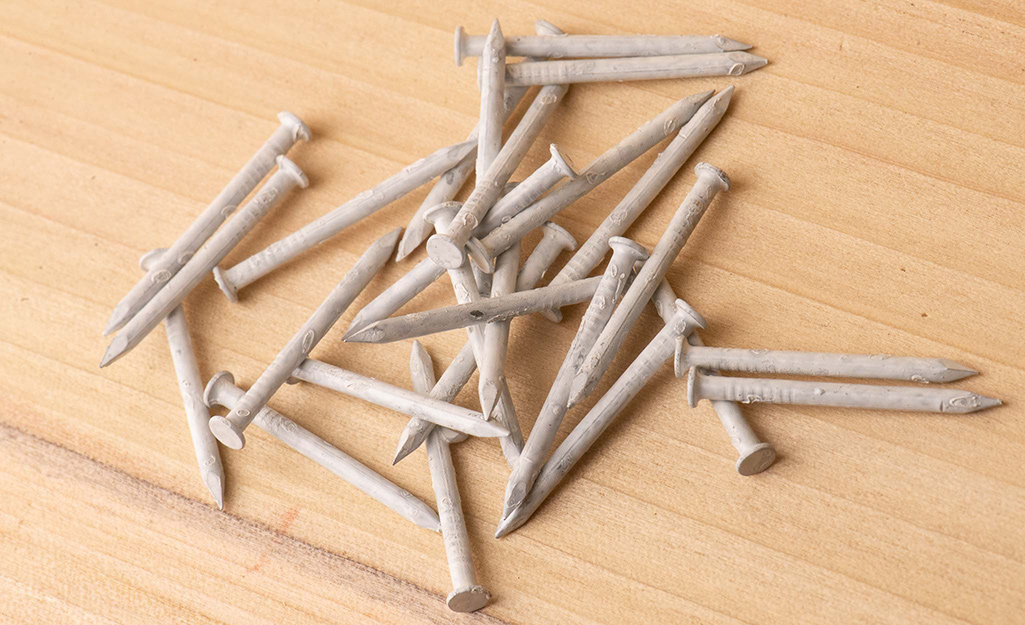 Aluminum nails piled on a table.