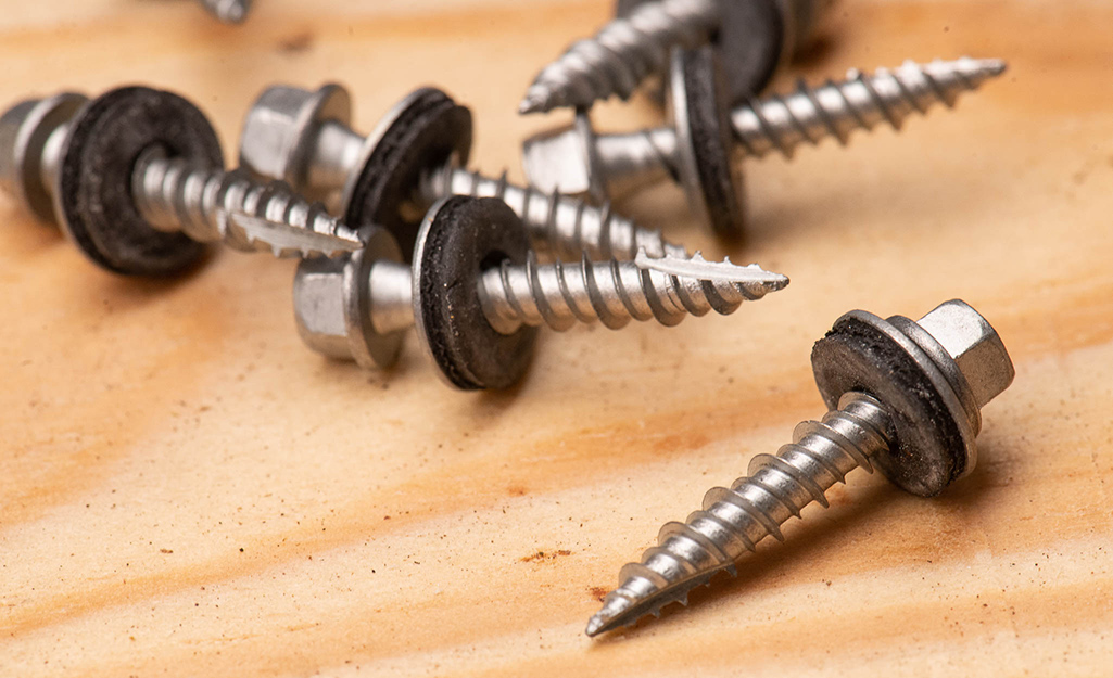 Roofing screws scattered on a table.