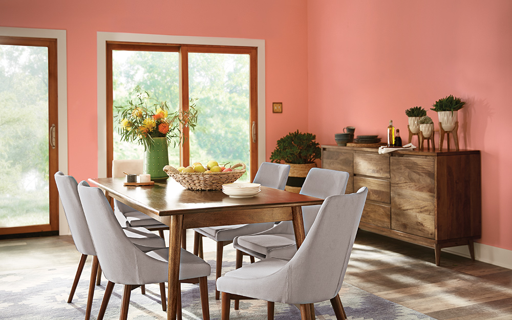 A dining room is painted in a melon paint with a matte finish.