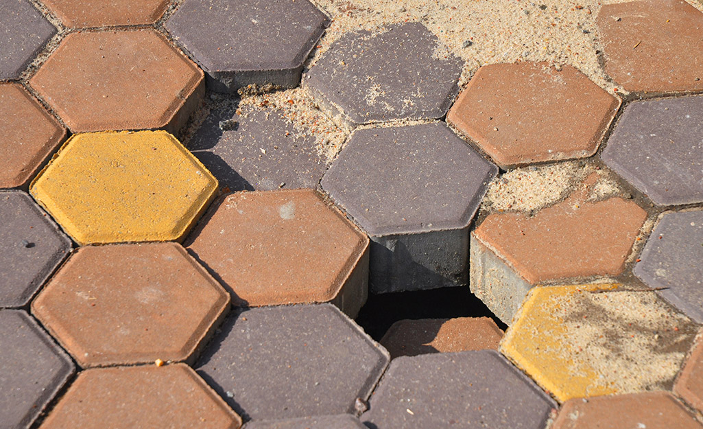 A section of sinking pavers on a patio.