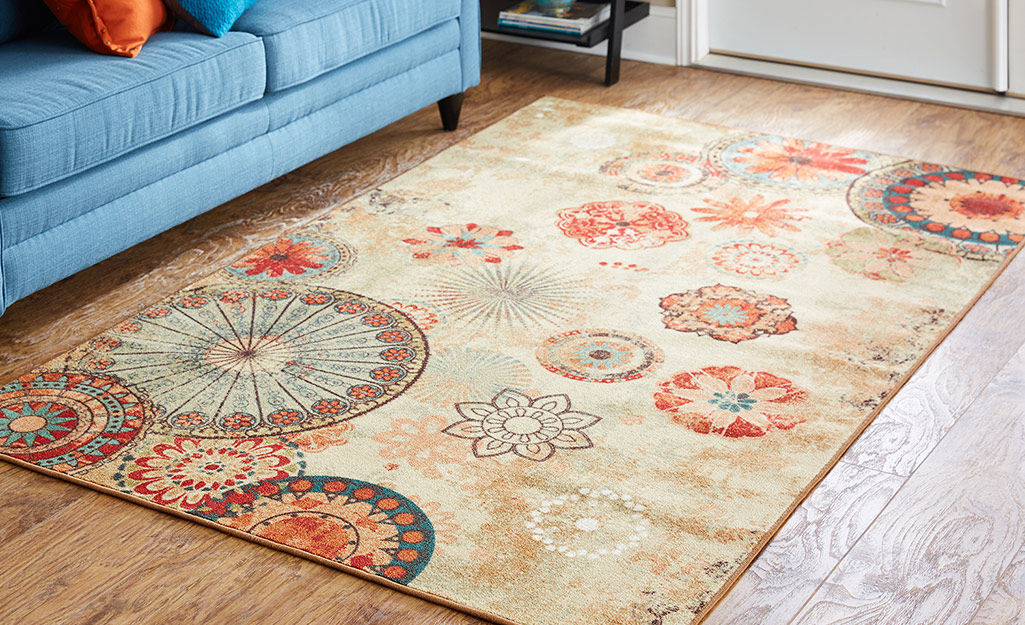 A medallion rug on a living room floor.