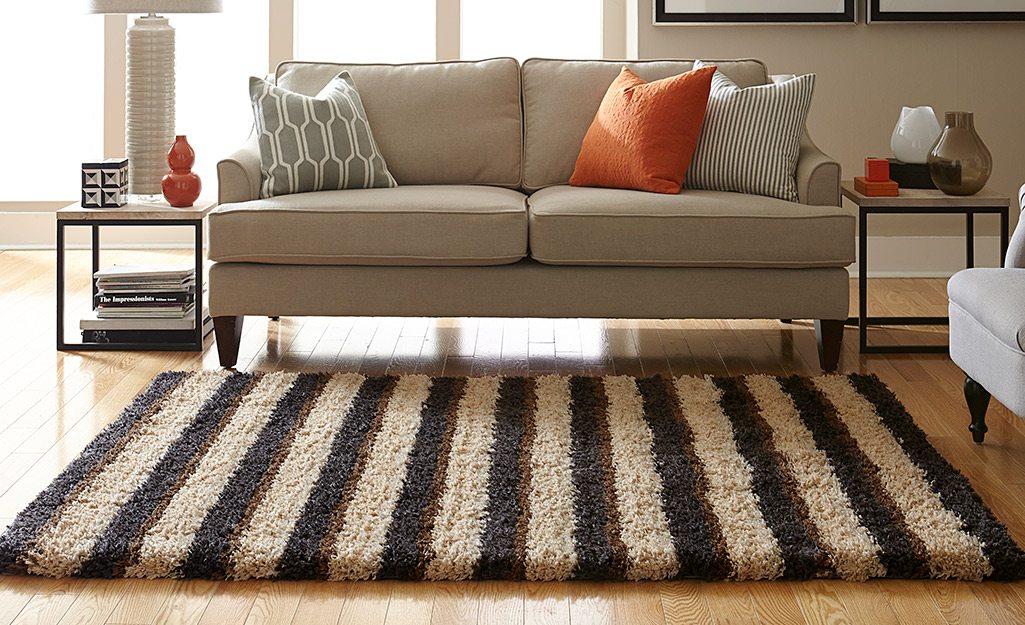 A striped rug in a living room.