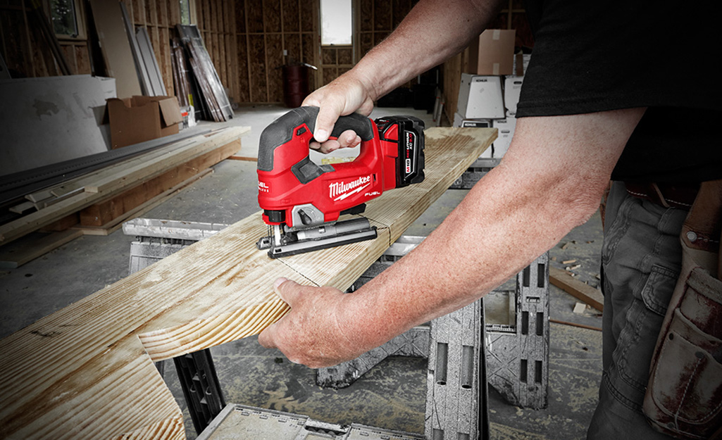 A person using a jigsaw.