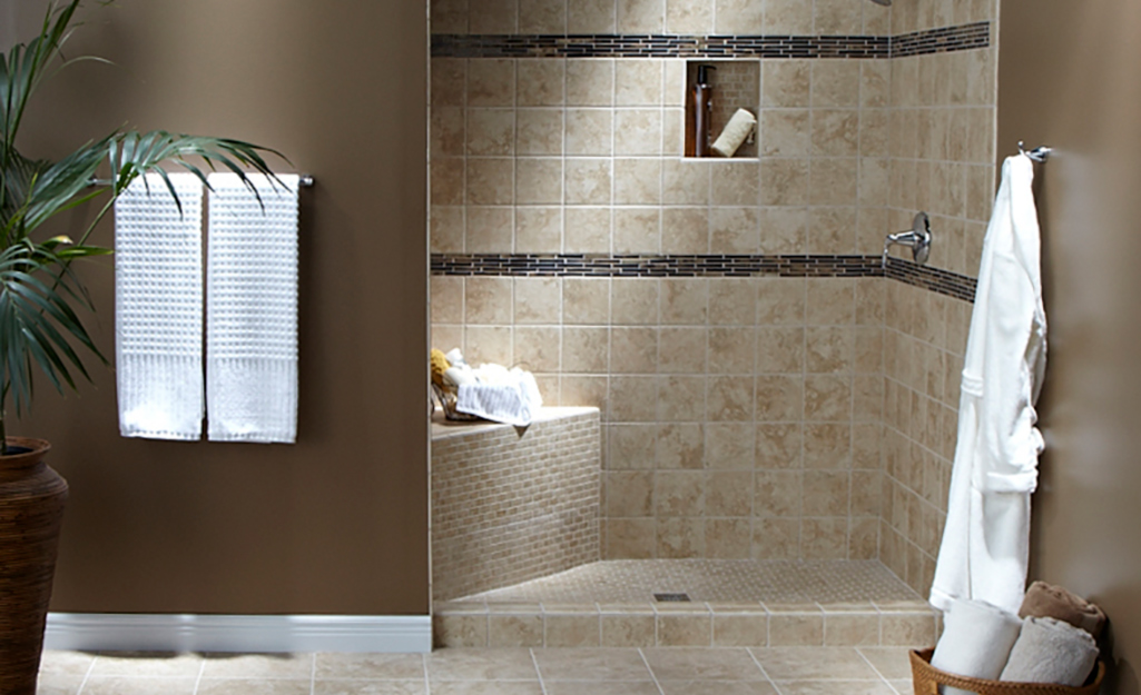 A shower with tiled walls and base.