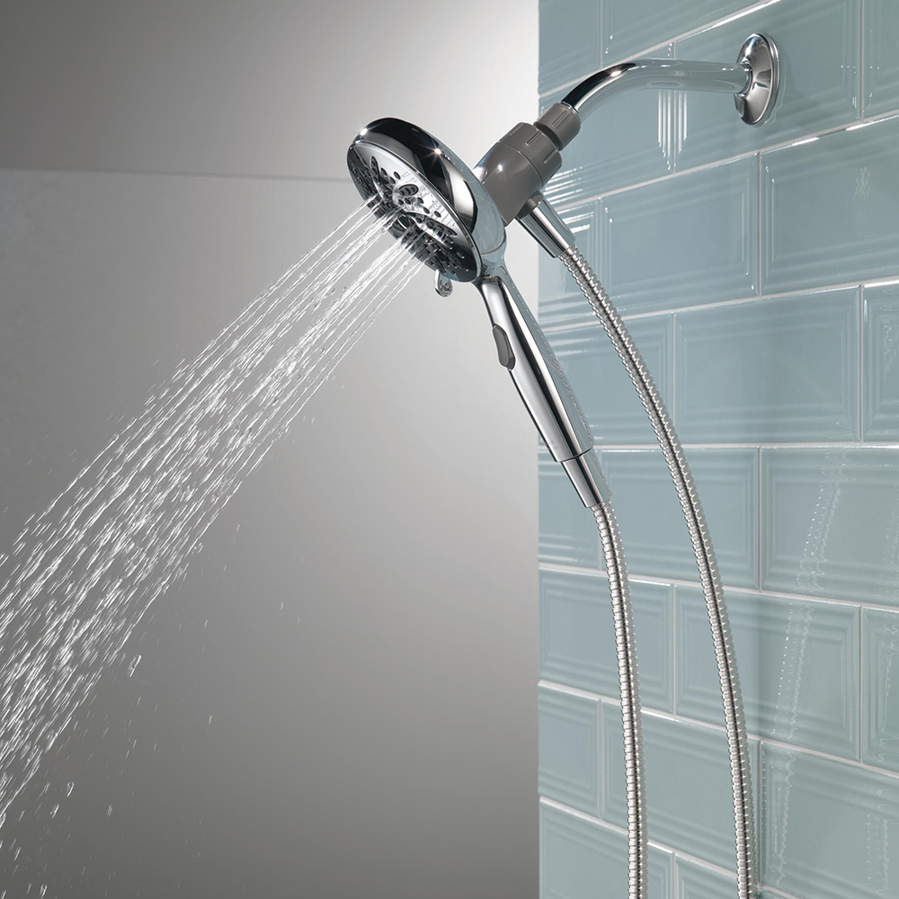 A hand-held shower attachment sprays water.