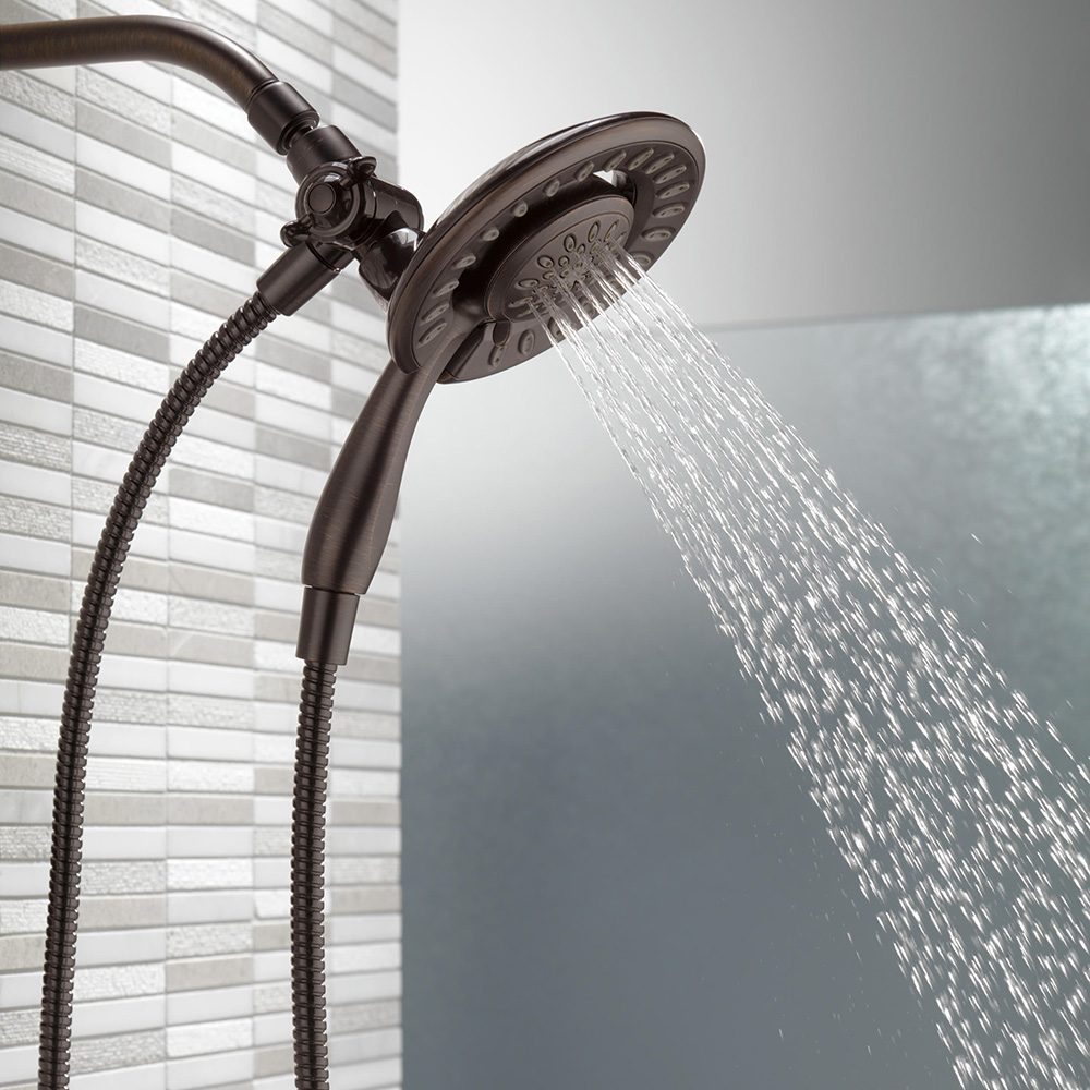 A hand-held shower attachment sprays water.