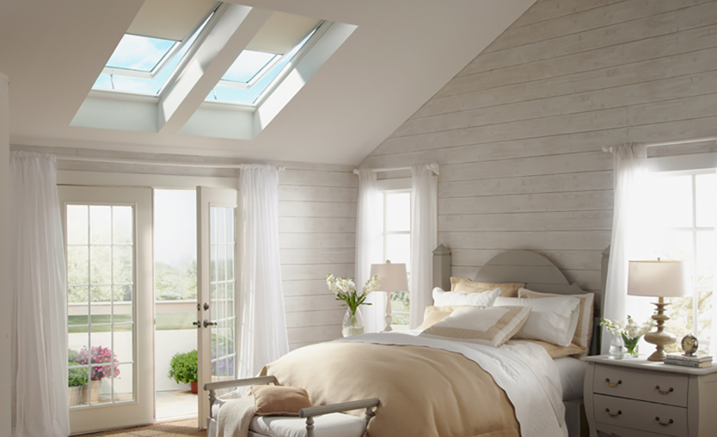 Skylights in a bedroom with a French door.