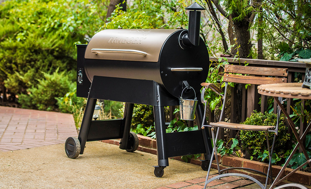 A pellet smoker grill on a patio