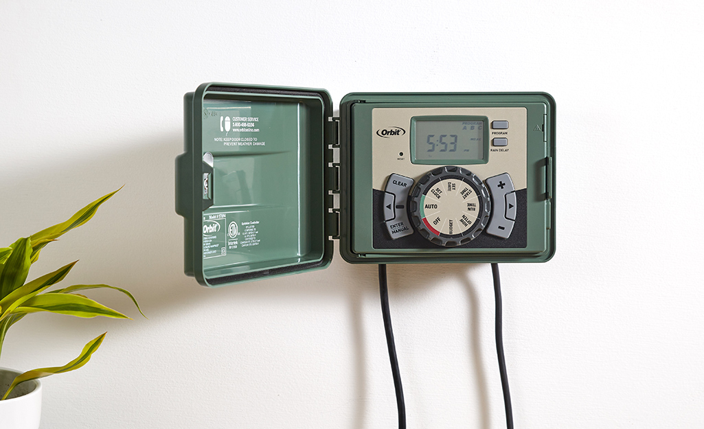 A green sprinkler system timer.