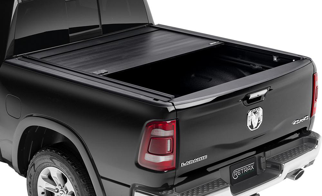 A closeup of a black pickup truck with a retractable truck bed cover