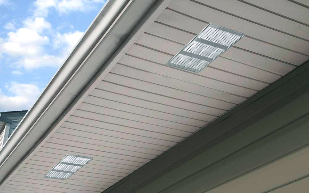 A soffit vent running along the side of a home.