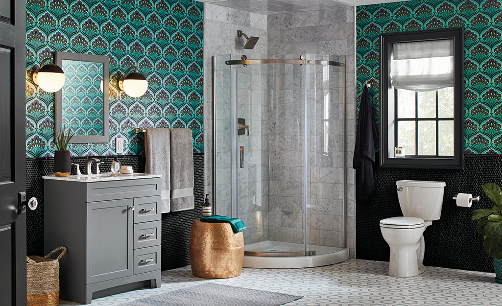 A bathroom with dark green patterned wallpaper.