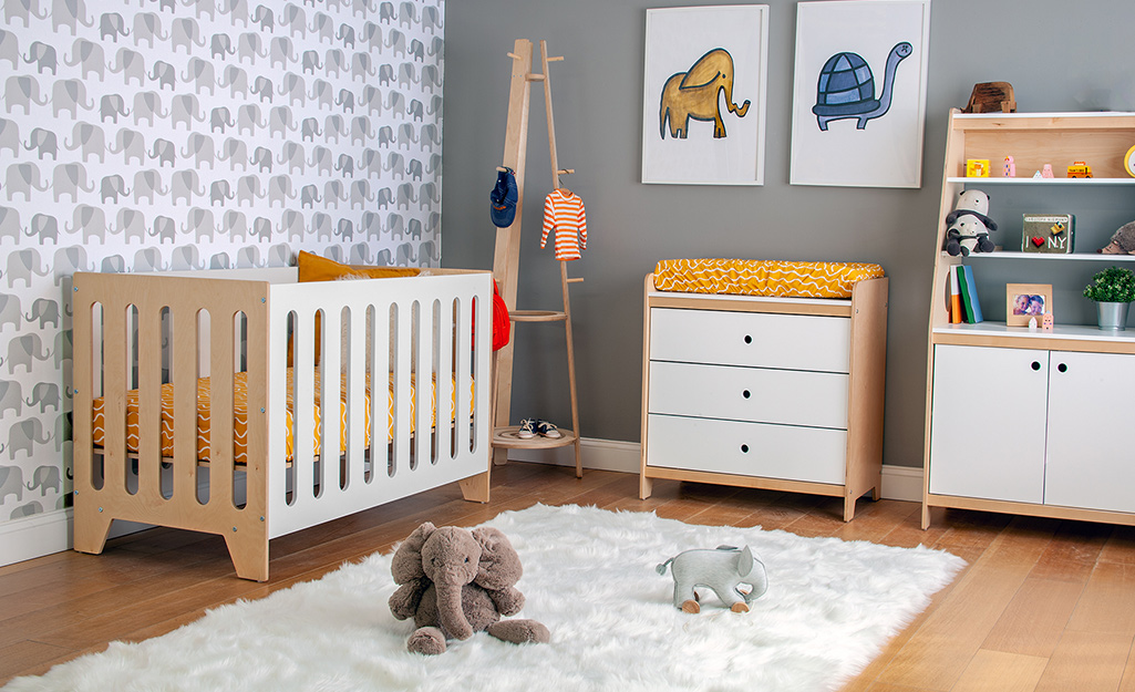 A children's nursery with elephant patterned wallpaper