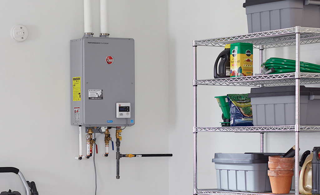 A tankless water heater installed on a wall in a garage