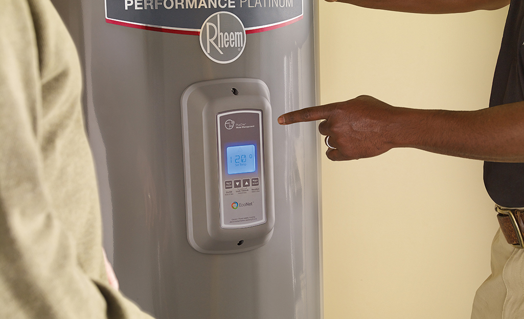 A person points to a display on a water heater