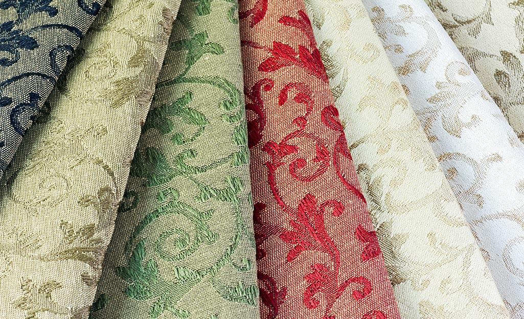 Drapery fabric rolled into rows.
