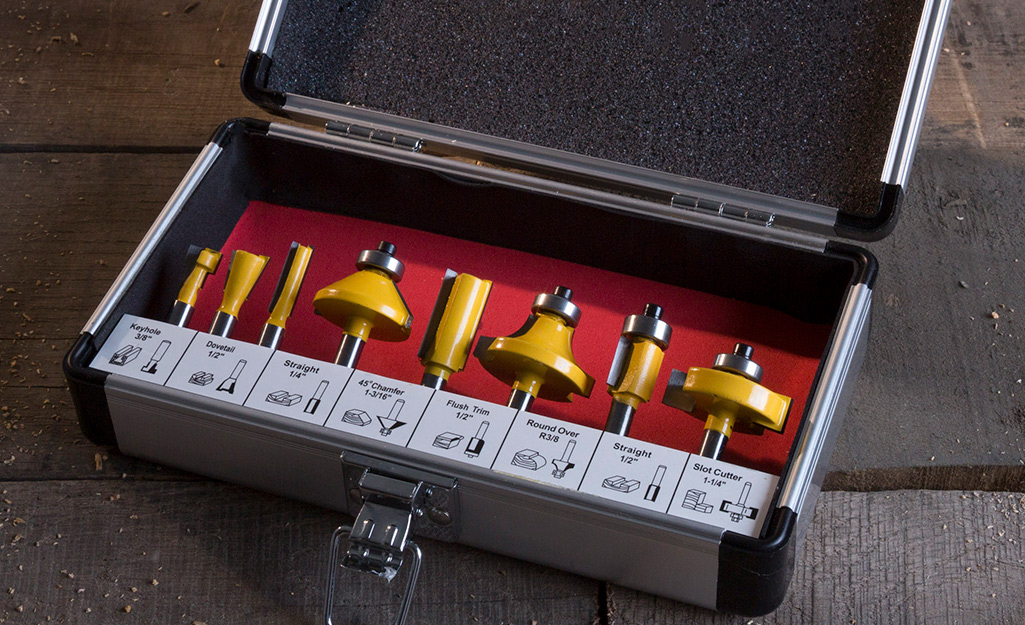 A black tool case holds eight wood router bits, including a keyhole bit, straight bits and a slot cutter.