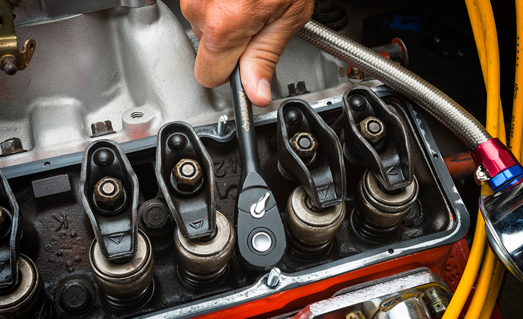 Someone using a socket wrench.