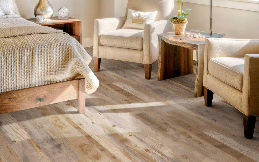A bedroom featuring vinyl plank flooring that looks like real wood.