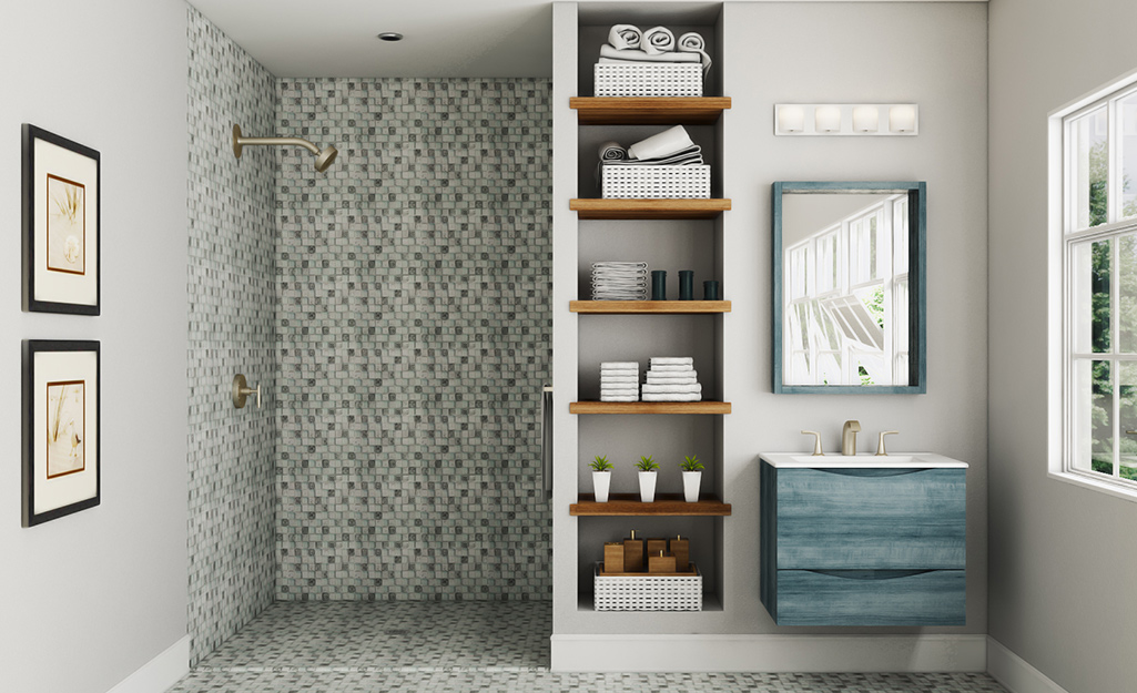 A walk-in shower with a gray and white tiled floor and walls in a bathroom.