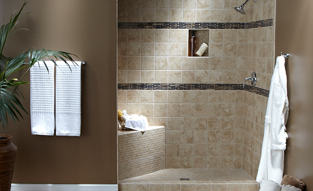 A walk-in shower with a built-in bench and wall niche.