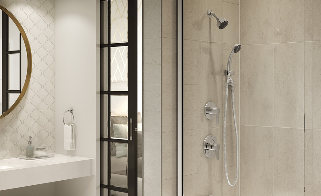 A bathroom with a walk-in shower with multiple shower heads.