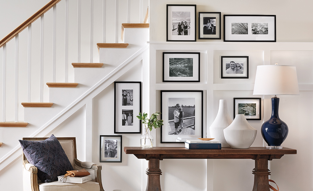 Framed photographs hung by a staircase as wall art.