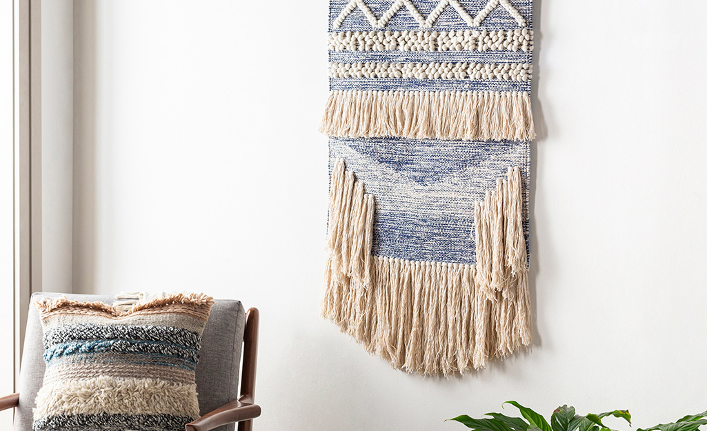  A weaving hung on a wall as wall art.