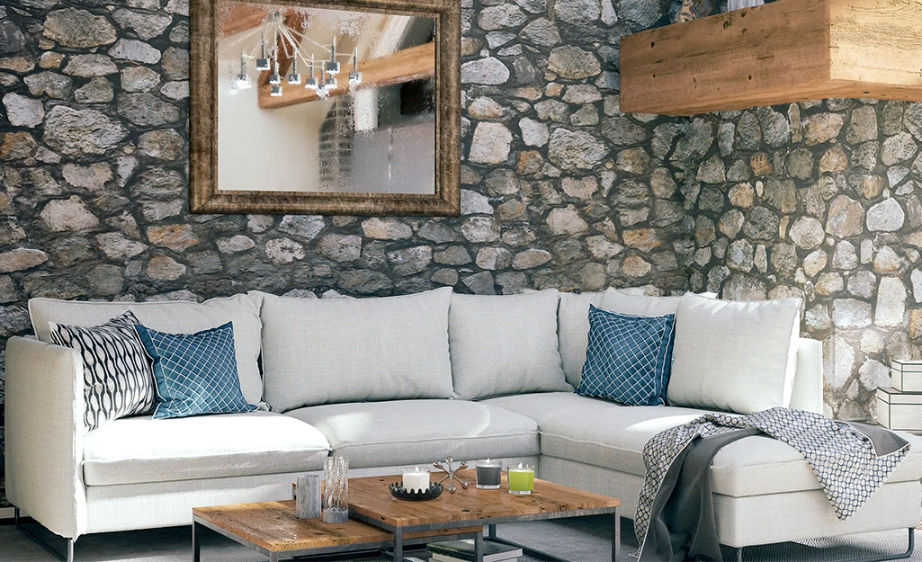 A living room featuring stone wall paneling on every wall.