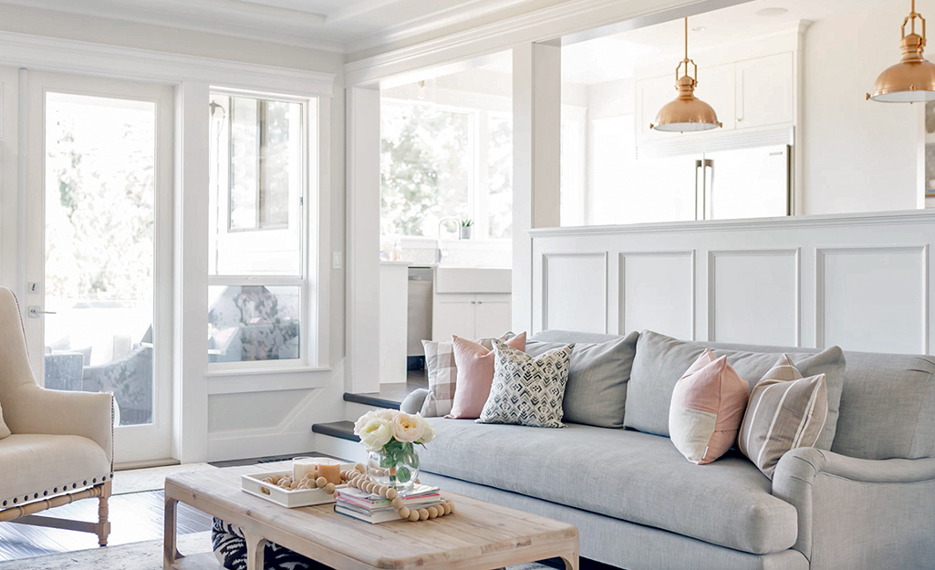 A coastal-inspired living room with classic paneling insets.